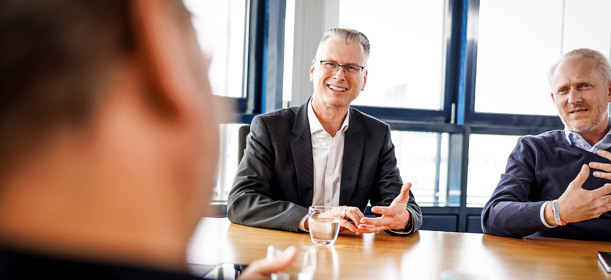 	We look across a conference table where Jens Fetzer and André Vogt from the CENIT leadership team are talking to the person opposite.	